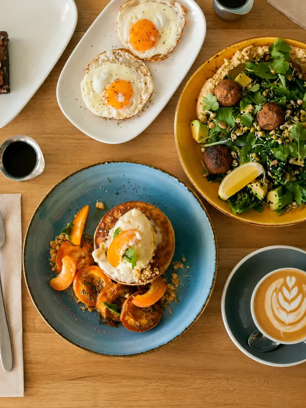 Brunch dishes and latte art on a cafe table
