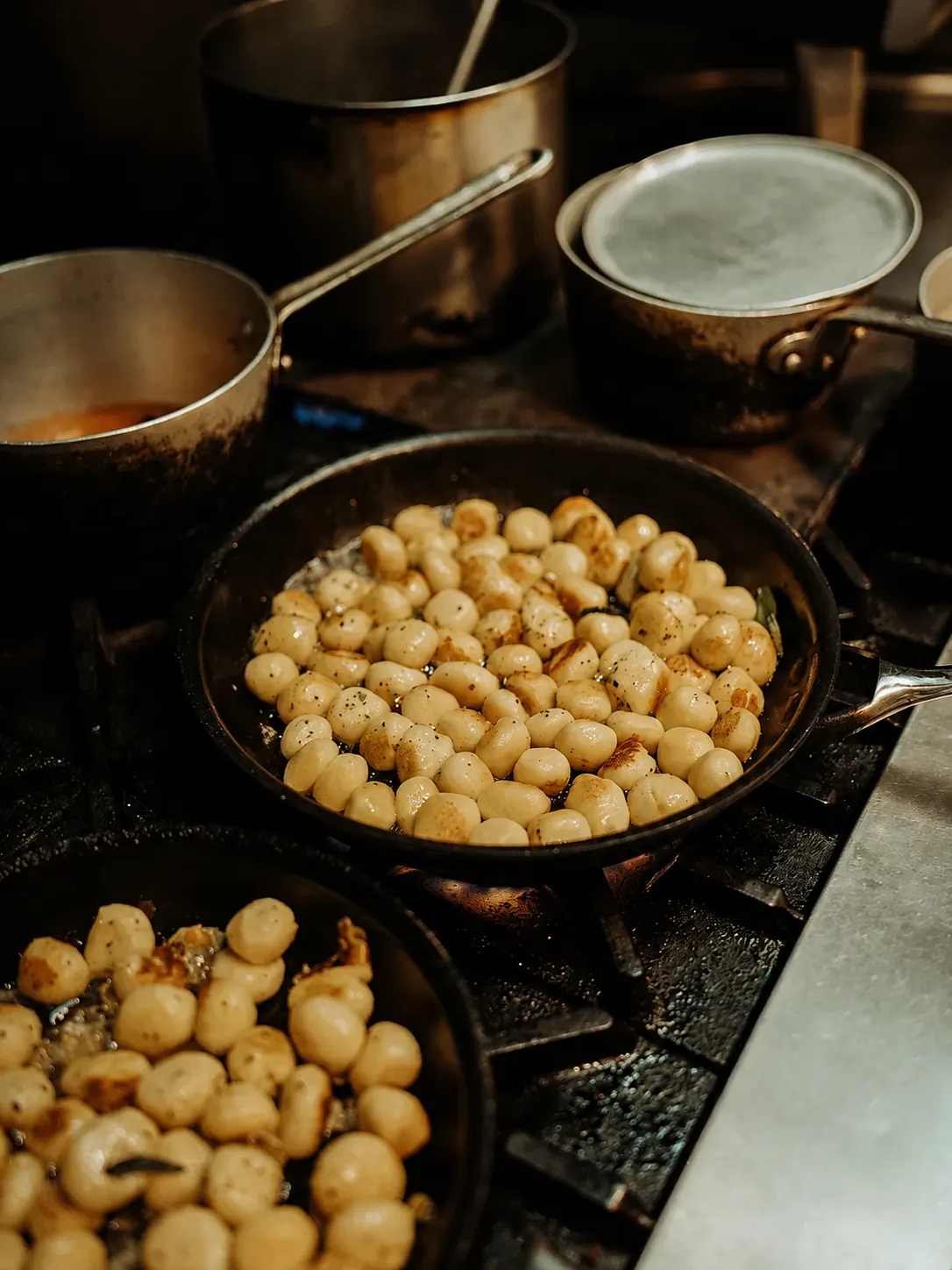 Food cooking in pans in the Benny and Brew kitchen